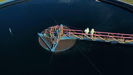 male specialists observing a water reservoir at a cleaning facility. top view