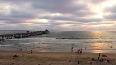 Sonnenflecken,-Die-Sich-In-Der-Abenddämmerung-Auf-Dem-Ozeanwasser-Mit-Wellen-Am-Imperial-Beach-Pier-In-Kalifornien-Spiegeln
