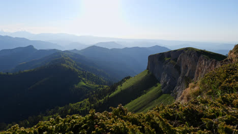Panoramic-landscape-view-of-the-rocky-Caucasus-Mountains-valleys-and-forests,-on-a-sunny-evening
