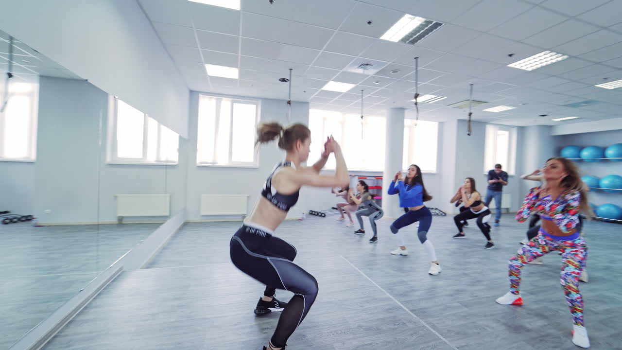 Women Group Fitness Class. Group of sporty women doing fitness and exercise indoors