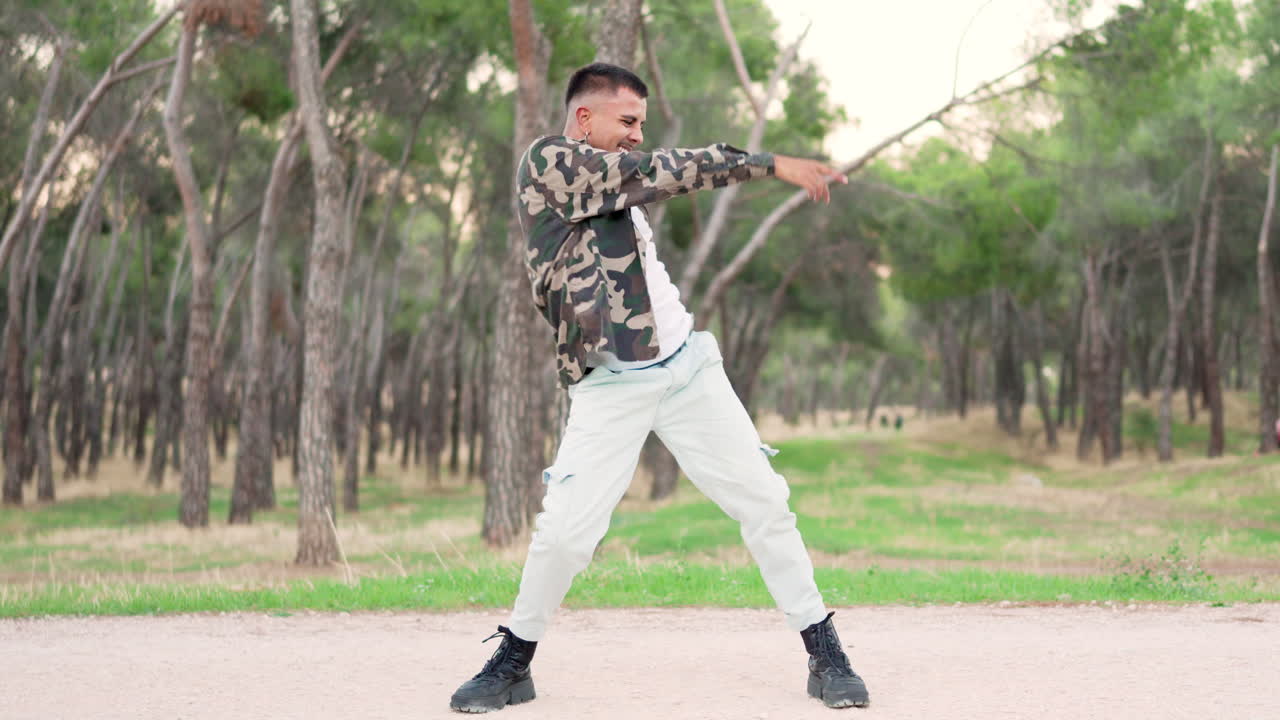 Young man dancing street dance in a park
