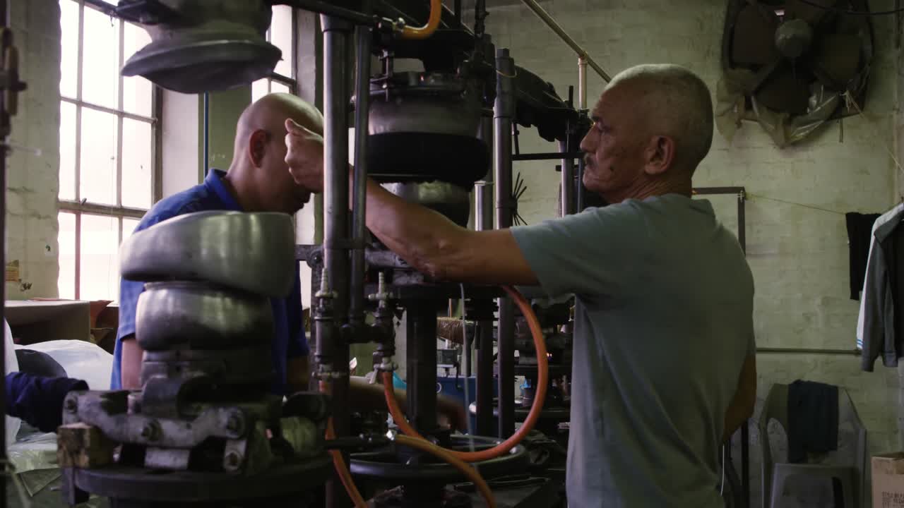 Mixed race men working at a hat factory