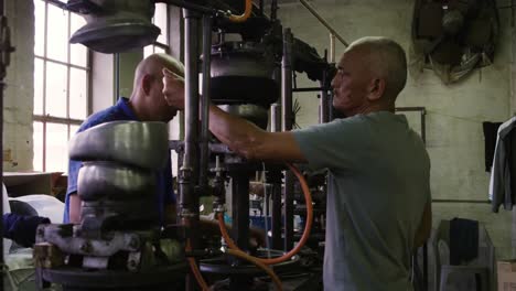 mixed race men working at a hat factory