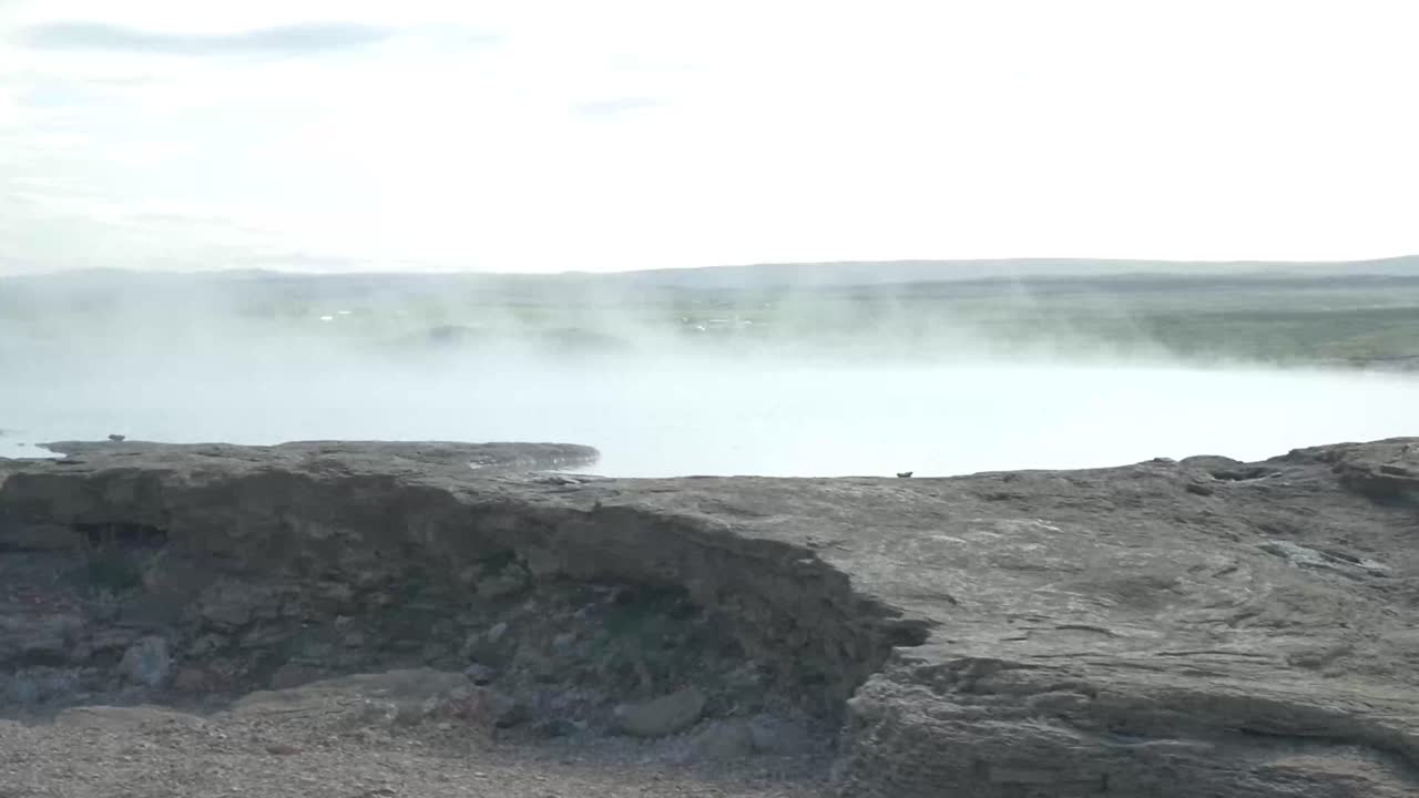 Misty Geothermal Hot Spring in Volcanic Landscape