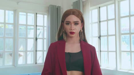 young fashion transgender woman wearing red clothes walking and posing in home