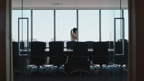 asian business woman using smartphone corporate sales executive chatting to client financial advisor negotiating deal sharing expert advice having phone call in office looking out window