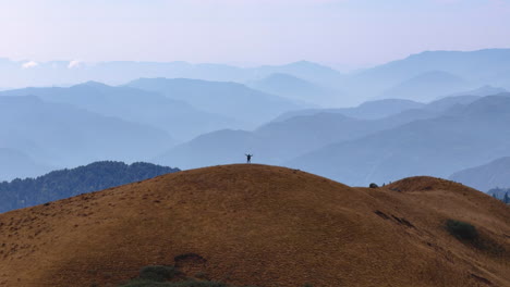 drone shot of a male tourist embracing the successful trek nepal pikeypeak