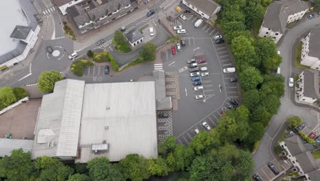 Aerial-exterior-view-of-a-supermarket,-showcasing-the-building,-parking-lot,-and-surrounding-area-in-the-UK