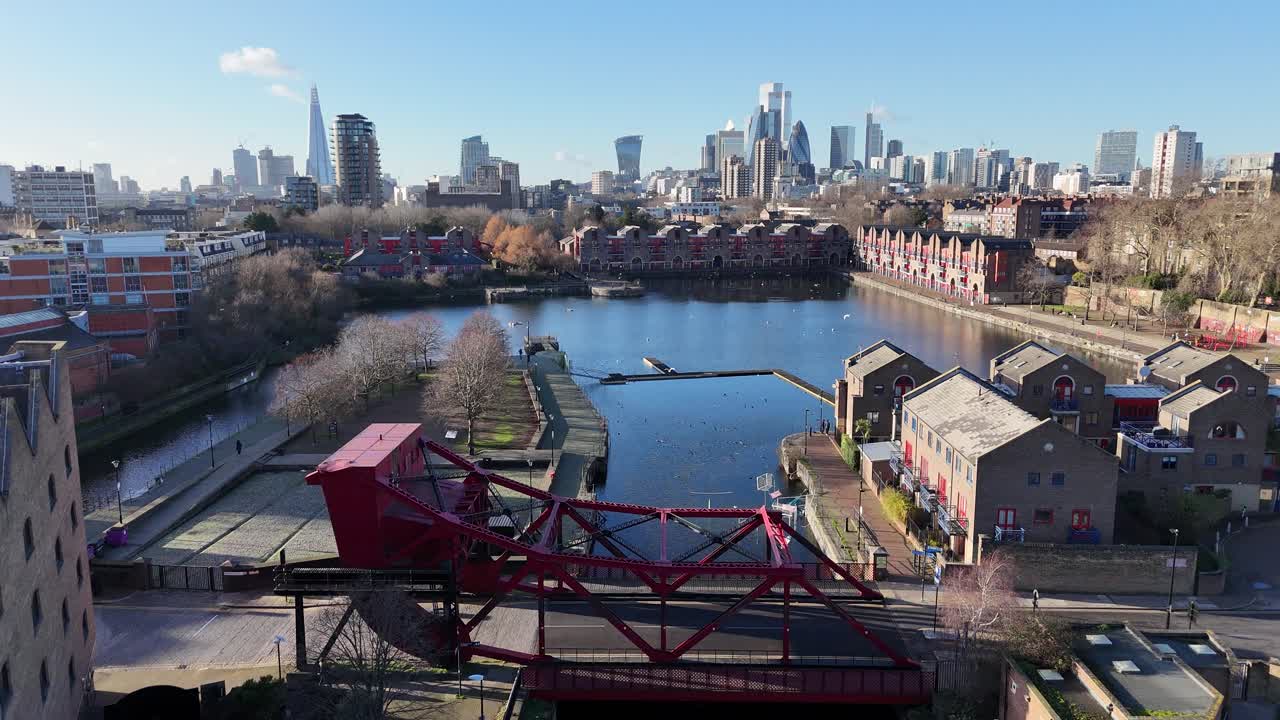 Shadwell Basin East London UK pull back drone aerial reverse reveal bascule,lift bridge,