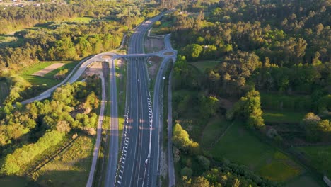 Aerial-View-Of-Highway-And-Roundabouts-With-Dense-Forest-On-A-Sunny-Day-In-Italy