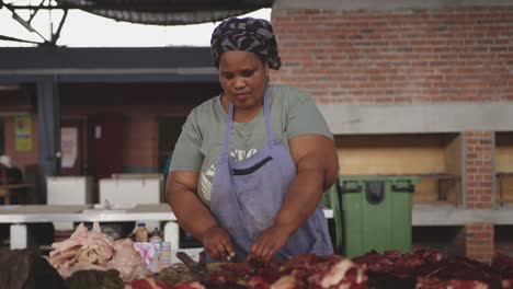 african woman cutting the meat