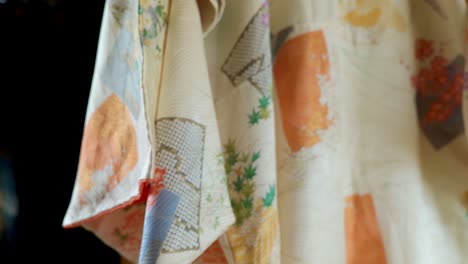 a traditional japanese kimono for a woman hanging in an old traditional japanese house