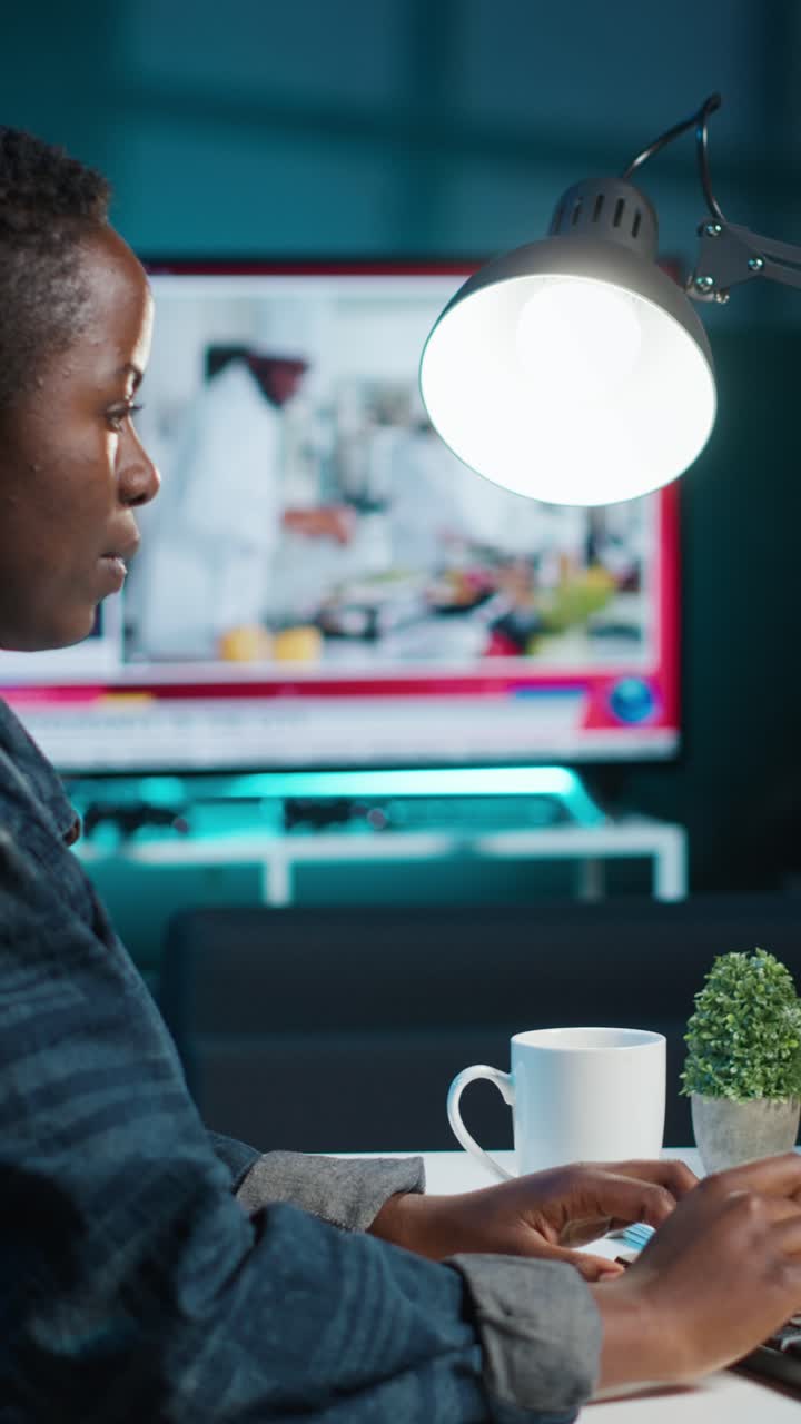 Vertical video AI expert writes code on laptop in apartment office