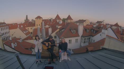 outdoor jam session, fisheye lens. young people play and sing on the roof.