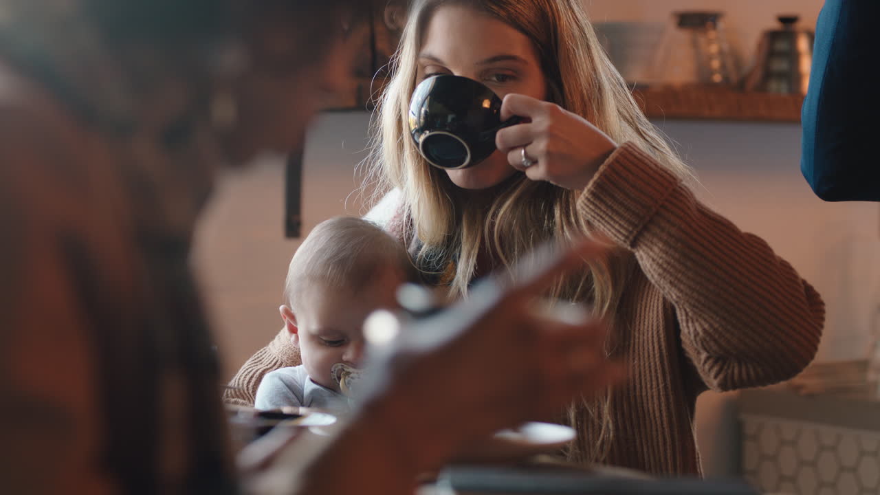 young mother caring for baby in cafe  nurturing child relaxing in busy restaurant drinking coffee enjoying motherhood