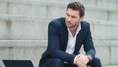 Businessman-sitting-on-stairs.-Male-manager-using-smartphone-on-street