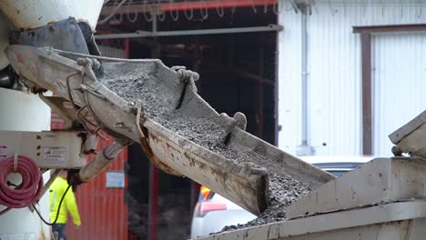 the production of cement, running down from a mixer machine, at a construction site