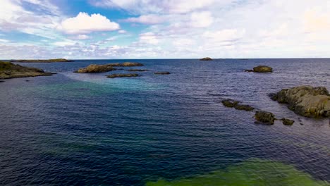 4K-60fps---Drone-flying-over-sandy-beach-over-crystal-clear-water-on-a-beautiful-sunny-summer-day