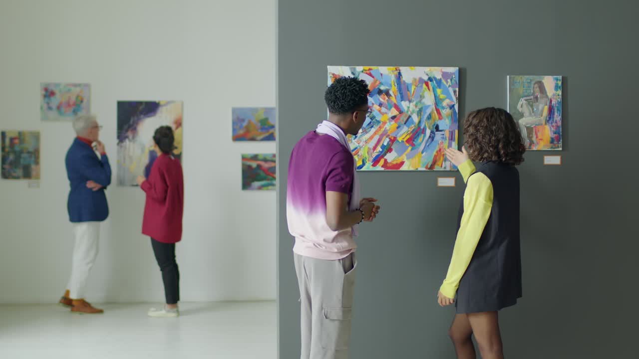 Couple Discussing Painting in Art Gallery