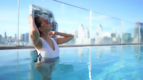 sexy bold asian model swimming at a hotel pool pattaya