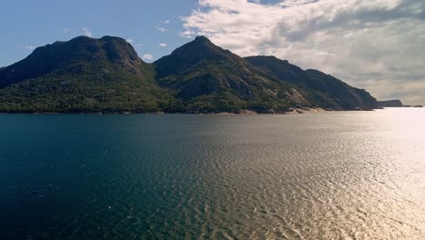 Aerial-view-of-hills-in-Freycinet-National-Park-with-a-calm-lake-at-background-in-Tasmania,-Australia