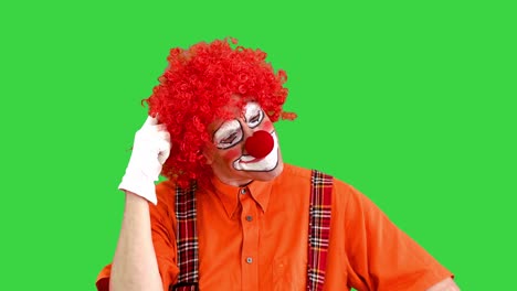 happy clown has an idea, finger up on a green screen, chroma key