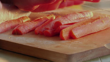 a chef slices carrots with a knife 1