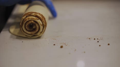 Baker-Rolling-The-Dough-With-Cinnamon-Filling