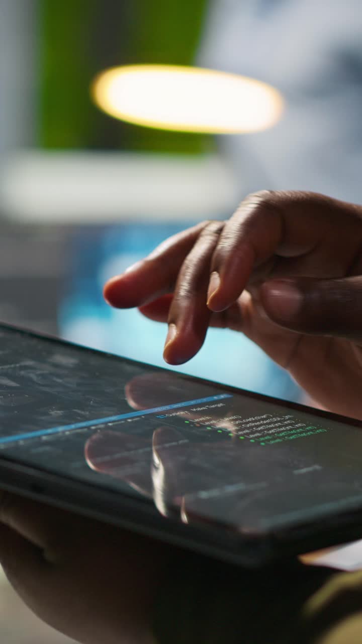 Vertical video Close up of engineer using tablet to write code, developing machine learning API