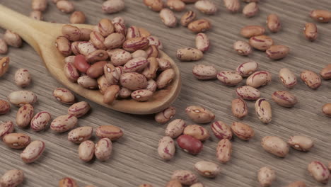 dry red beans on wooden spoon, vegan vegetarian protein source rotating, mediterranean healthy diet