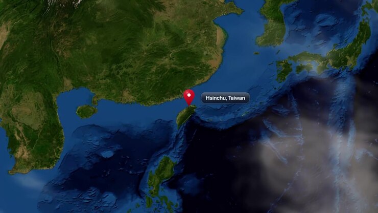 Satellite camera zooms from outer space directly down to Hsinchu, Taiwan with a pin marker. Includes NASA public domain imagery.