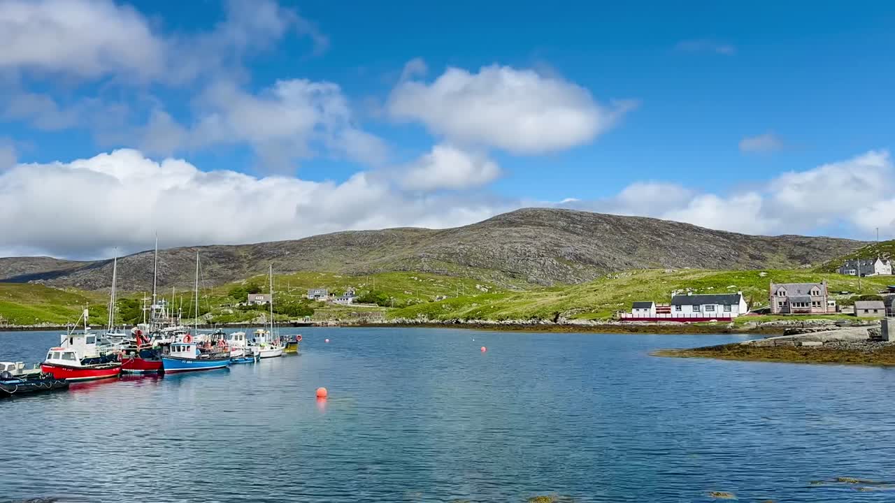 Timelapse di barche che ondeggiano nel lago a Scalpay Harbour, con movimenti di nuvole drammatici in alto, che mostrano il cambiamento del meteo e la vita marittima costiera