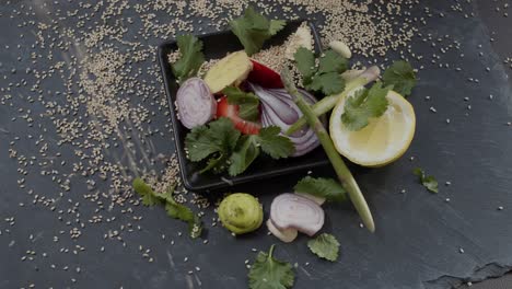 sesame seeds pouring over raw food ingredients in slow motion