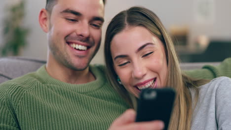 Laughing,-funny-and-a-couple-with-a-phone-on-home