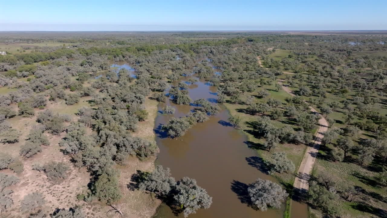 Aerial: Drone flying over flooded bushland in Bourke, NSW, Australia