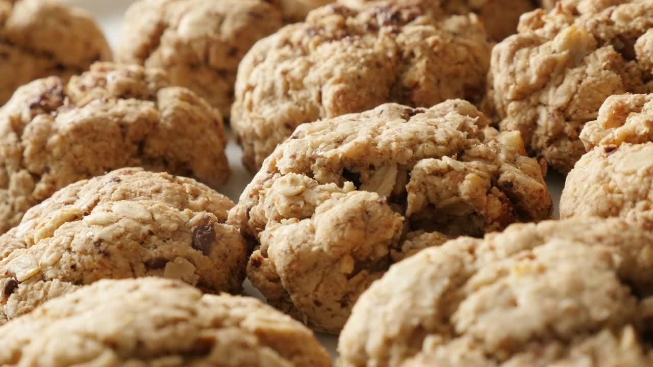 Tasty oatmeal biscuits served on plate shallow DOF 4K 2160p 30fps UHD panning footage - Pile of homemade chocolate chip cookies close-up slow pan 3840X2160 UltraHD video