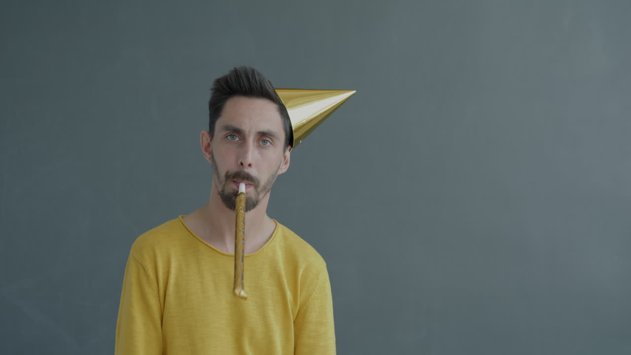 Man with party hat and horn