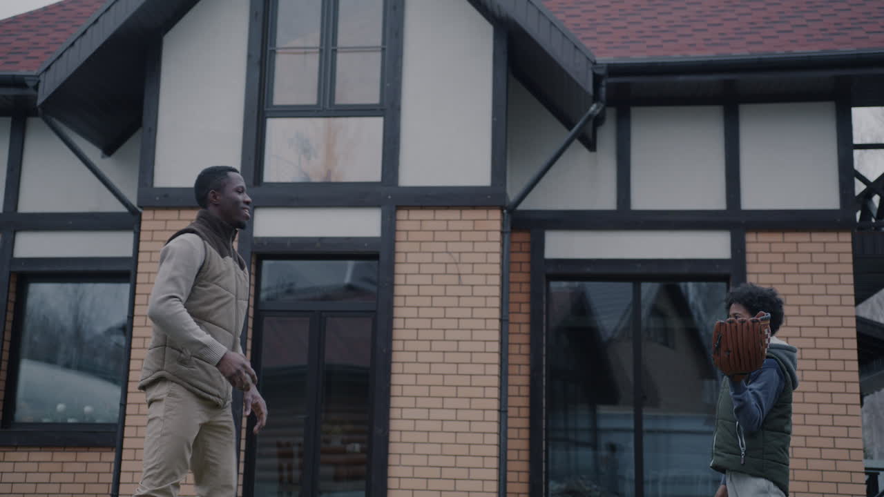 Father and Son Playing Baseball in the Backyard