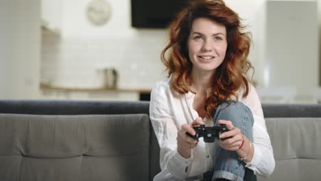 playful woman playing video game at home