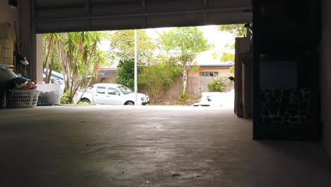 open garage door showing cars in driveway