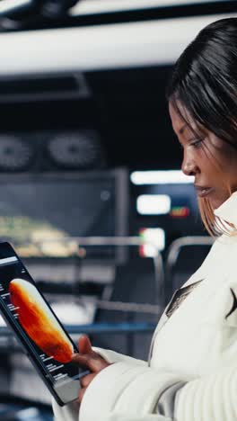 vertical video malfunction indicator blinking in starship over astronaut helmet next to laptop
