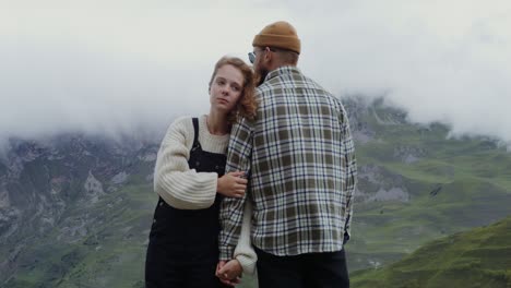 couple in love hiking in misty mountains