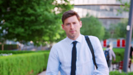 Portrait-Of-Businessman-Walking-Through-City-On-Way-To-Work