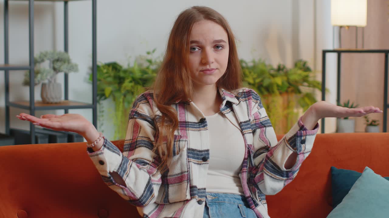 Confused woman raising hands in indignant expression asking why what reason of failure at home