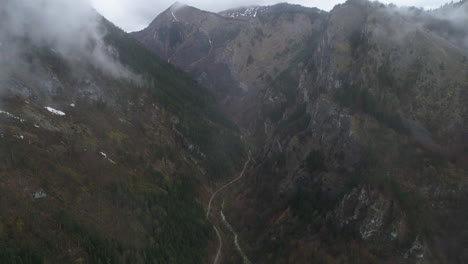 Dolly-out-shot-through-the-cloud-cover-of-Nemuna-National-Park,-Kosovo