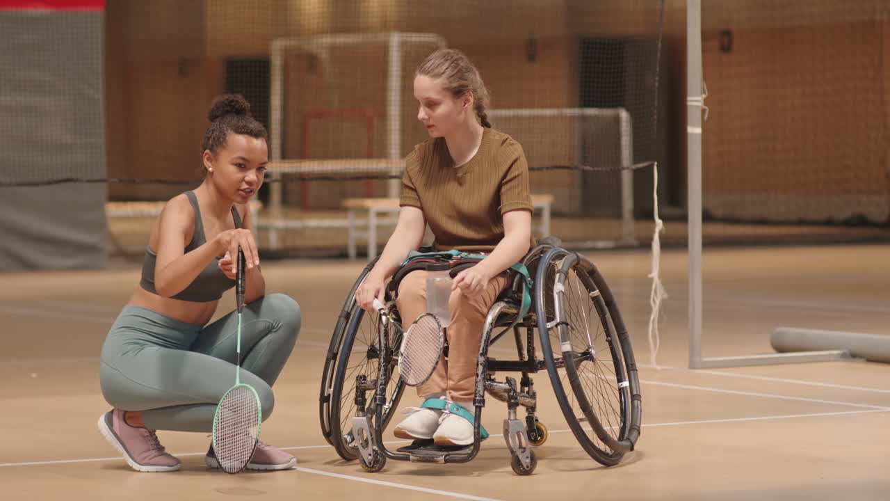 Two Female Athletes Talking on Court