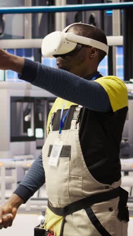 vertical video engineer in smart factory does maintenance using vr headset tech
