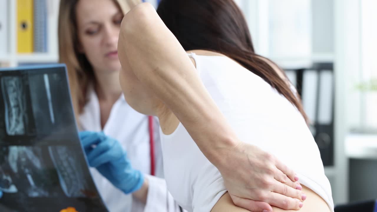 Doctor Examining Patient's X-Ray for Back Pain