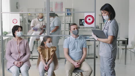 patients measuring temperature at hospital queue