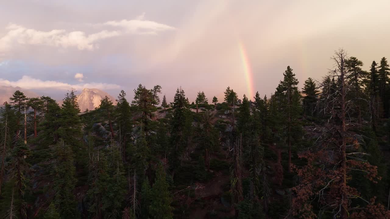 Drone shot of a double rainbow during golden hour in Yosemite National Park